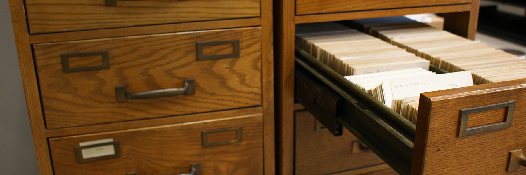 This is a close up view of a card catalog with one drawer to the right open showing the cards.
